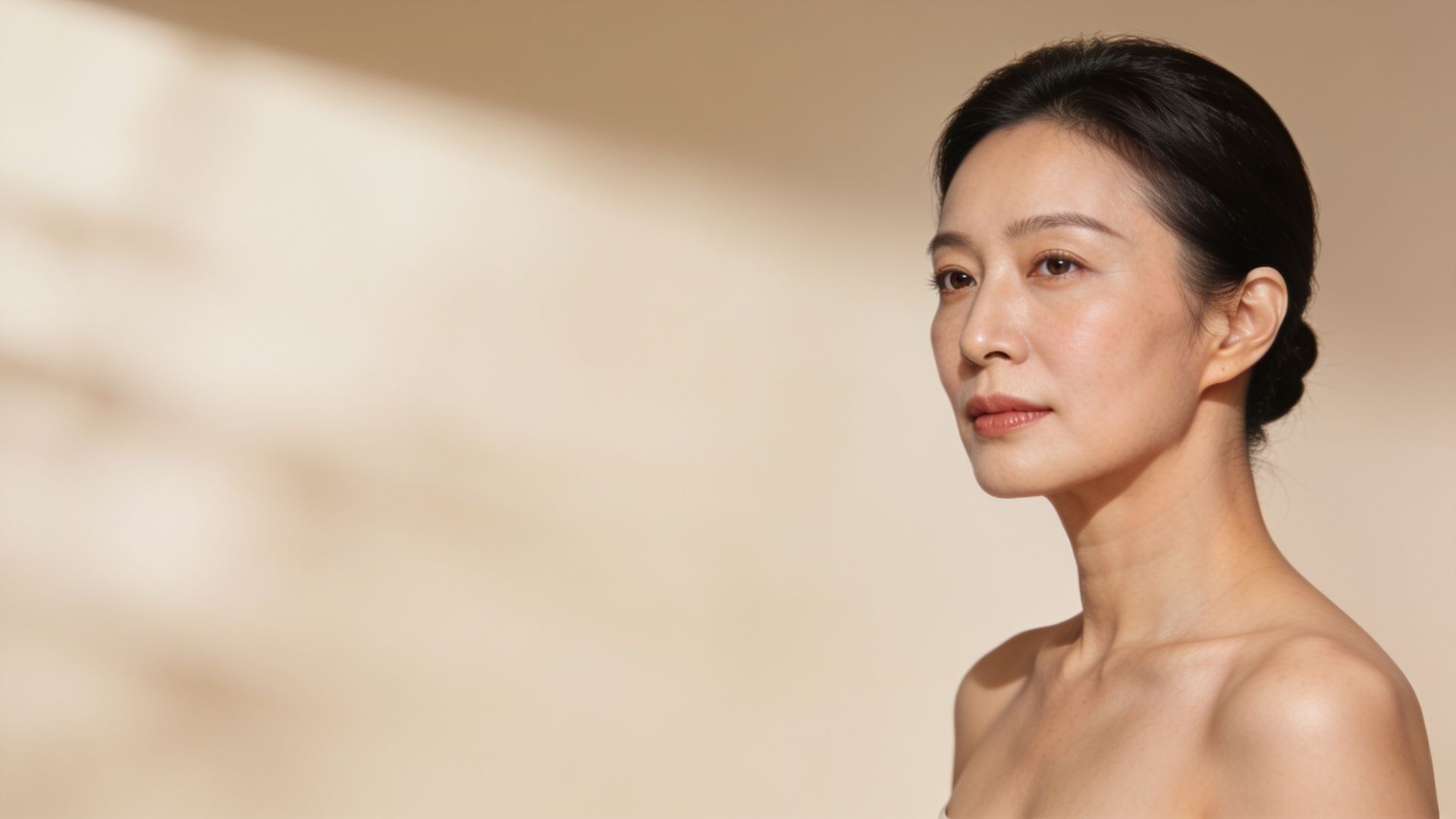 Woman in her early forties with even-toned, smooth skin
