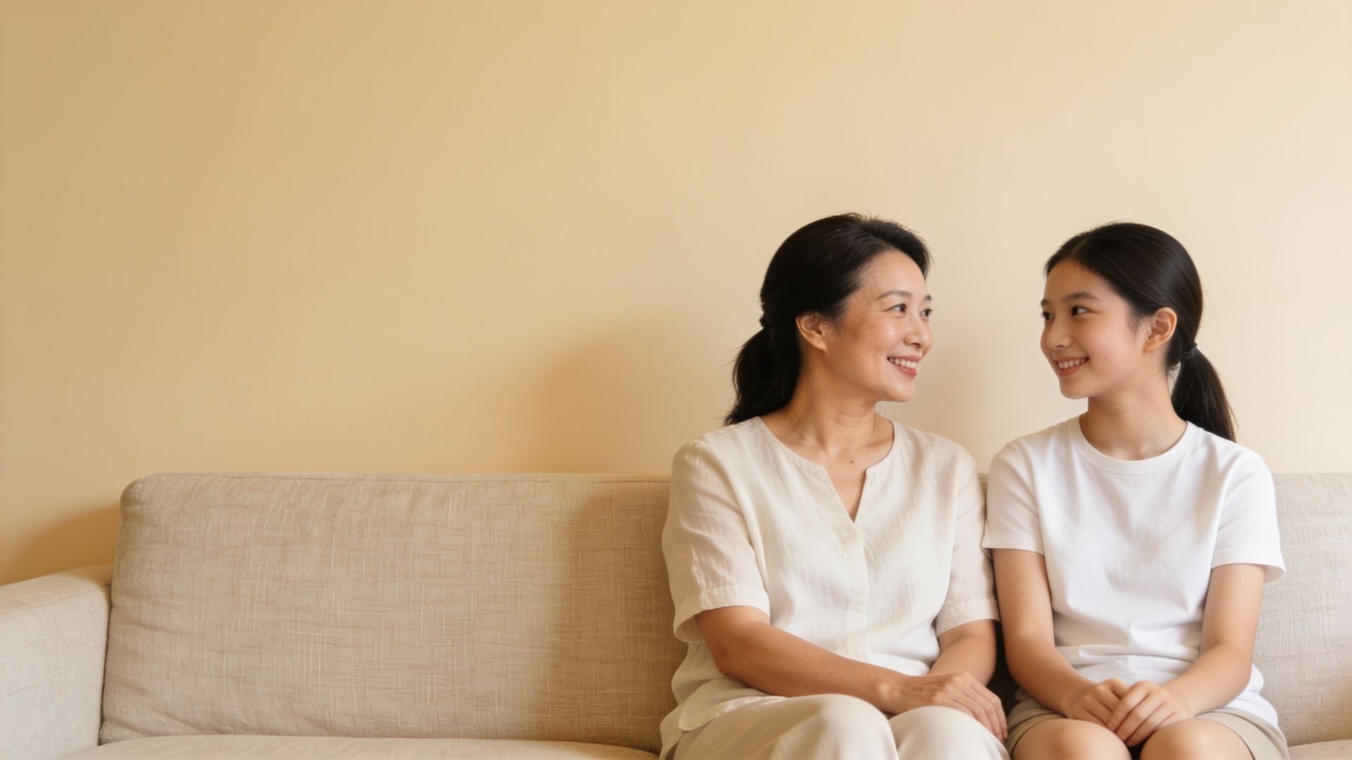 Mother and teenage daughter sitting together, illustrating a parent’s guide to teenage acne