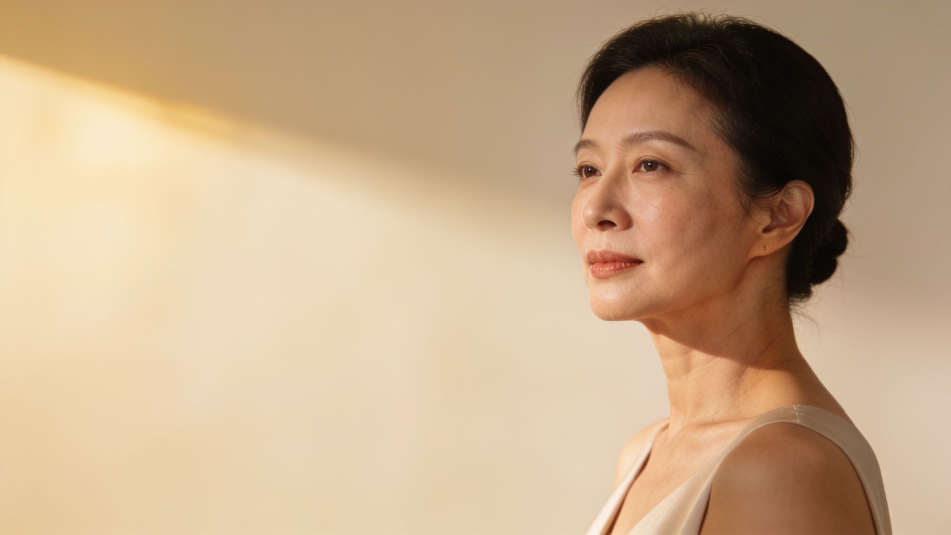 Woman in her late 40s with natural lateral cheek and jawline contours