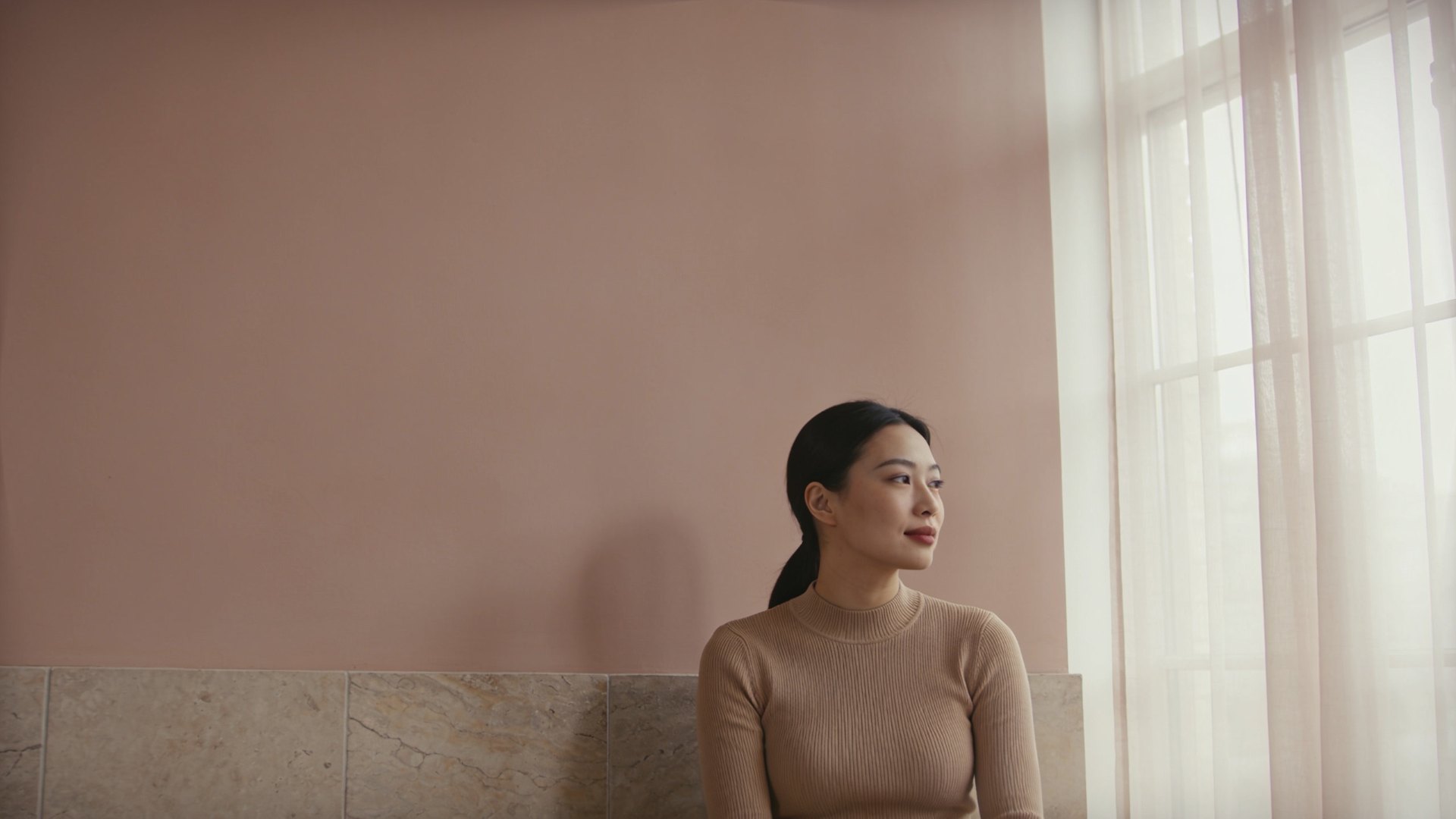 East Asian woman in her thirties with even, natural skin in soft daylight, representing laser treatment options at IN Eternity Clinic, Singapore
