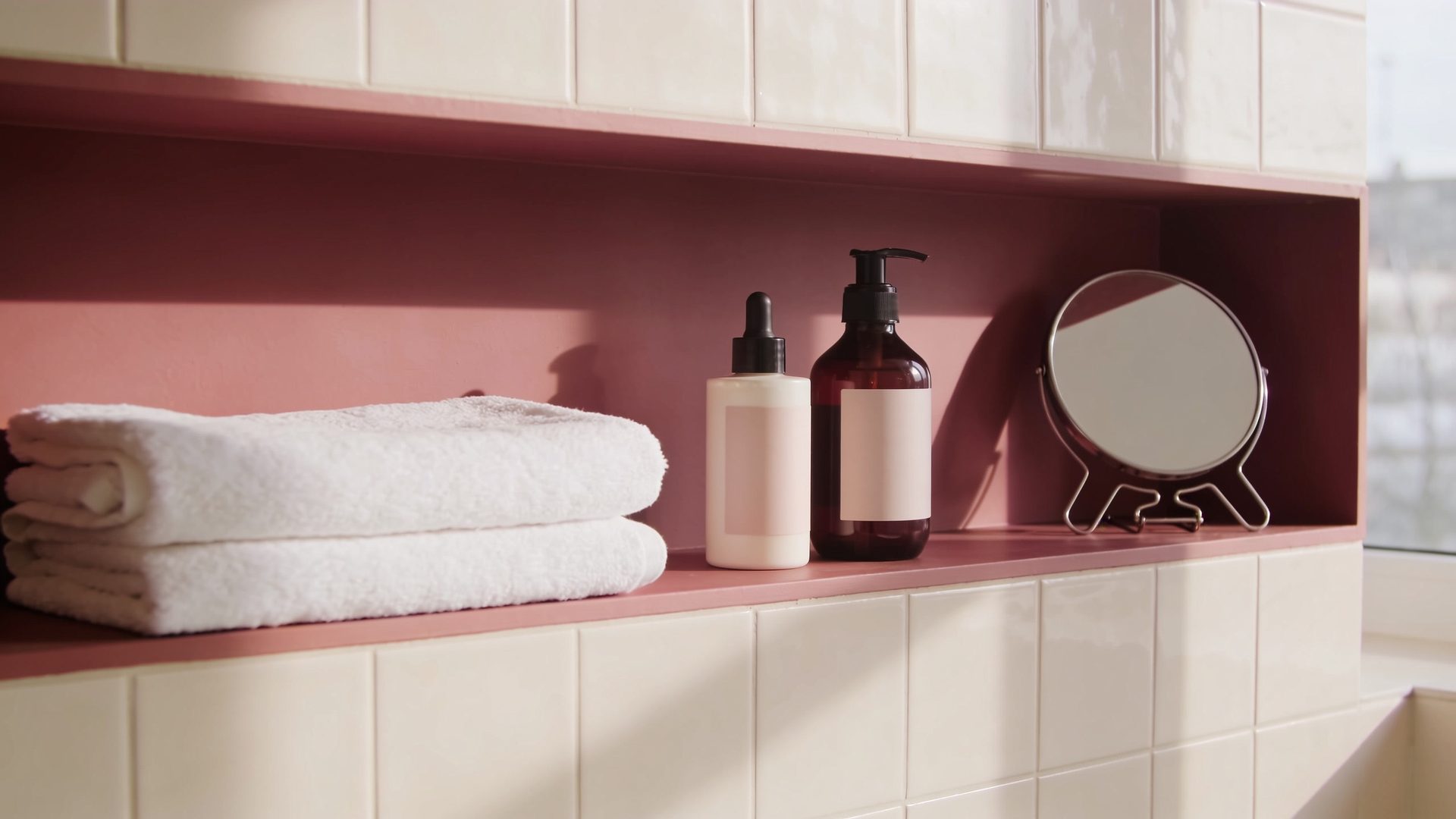 A bathroom shelf with unlabelled skincare bottles and a folded towel (illustrative image)