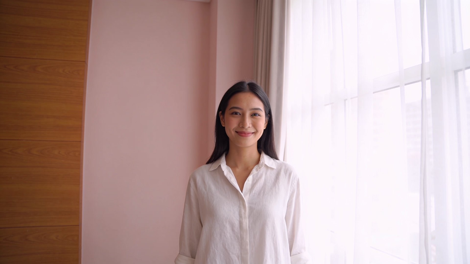 A Southeast Asian woman in her twenties with natural, even skin smiling in soft daylight, representing acne marks care at IN Eternity Clinic, Singapore