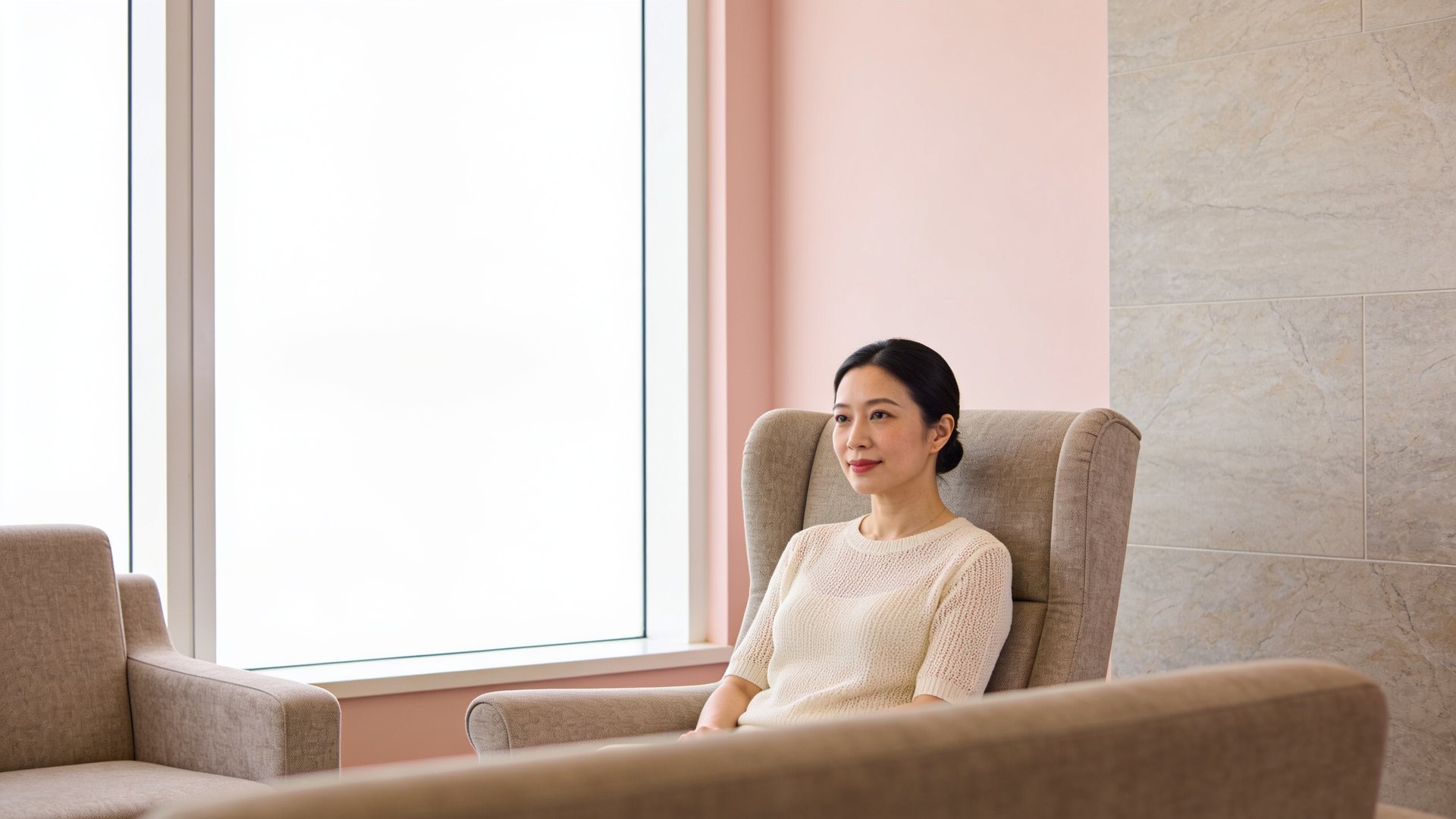Chinese Singaporean woman in her thirties sitting calmly by a bright window, representing sebaceous cyst assessment and removal at IN Eternity Clinic, Singapore