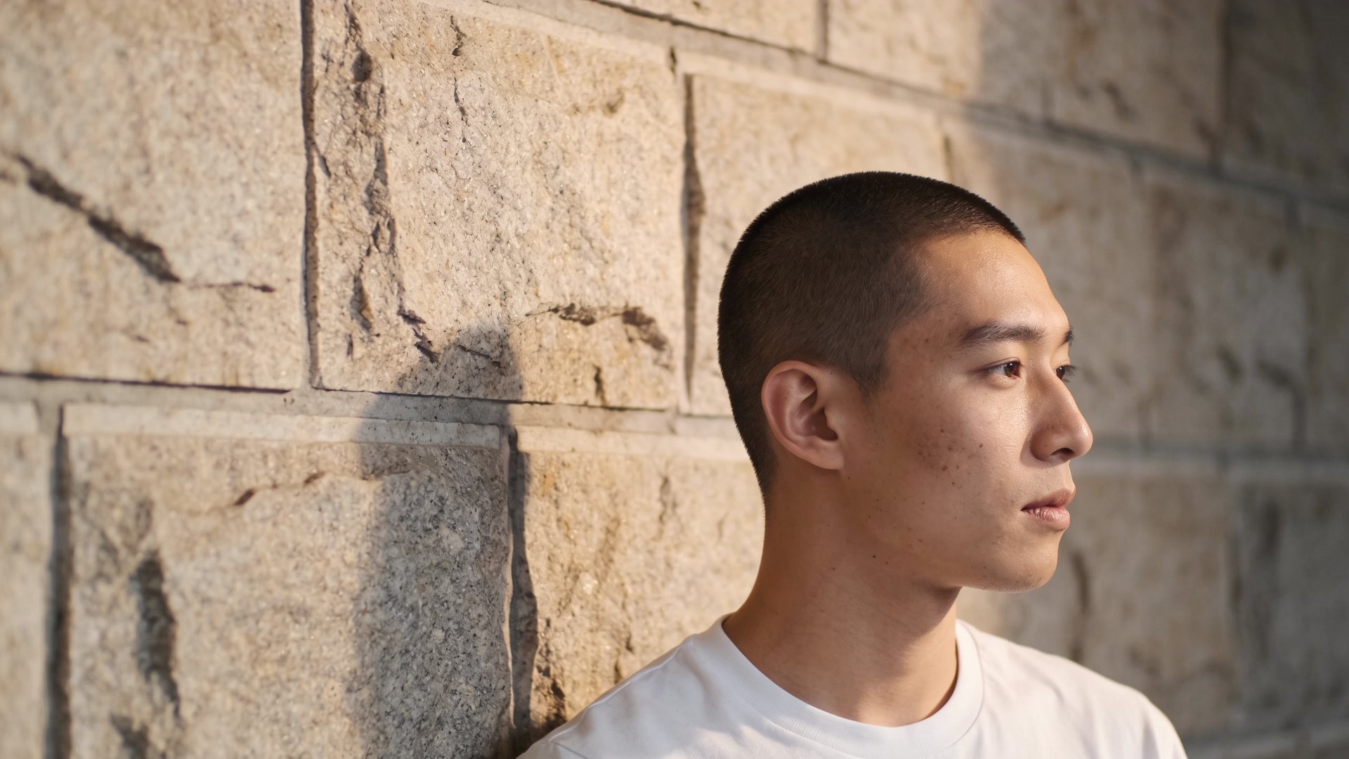 East Asian man in his late twenties with smooth cheek skin in soft side light, representing TCA CROSS for ice-pick acne scars at IN Eternity Clinic, Singapore